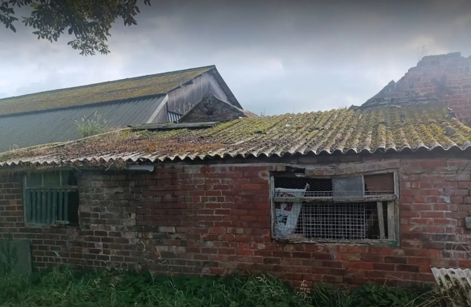 Agricultural buildings with corrugated roofs shown as asbestos farm building roof removal context for Teesside